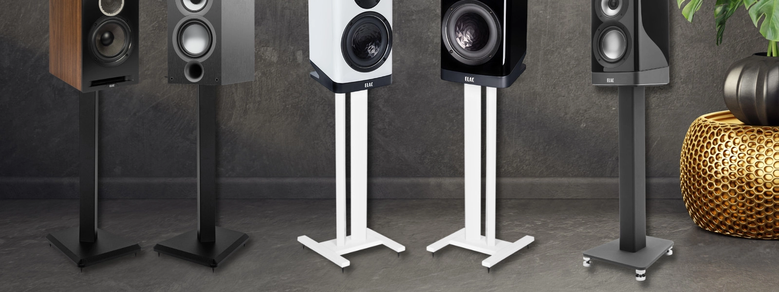 Bookshelf speakers on stands positioned at ear height in a home audio listening setup